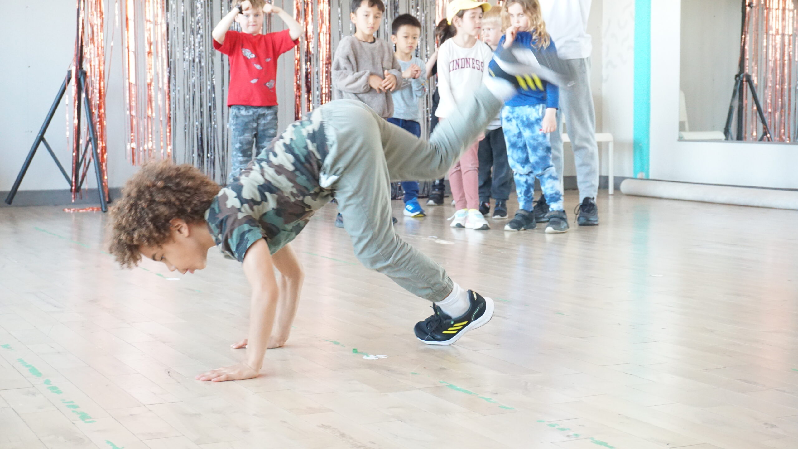 Kid doing handstand in a studio